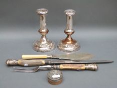 A pair of silver plated candle sticks, silver mounted carving set,