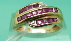 A 10K gold ring set with three rows of rubies and two diamonds (Size O)