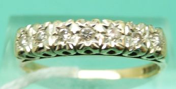 A 9ct gold ring set with seven diamonds (Size R)