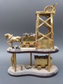 A brass model coal mine with horse, trucks and pit gear,