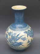 A large CH Brannam pottery bulbous vase with flared neck decorated with birds in foliage.