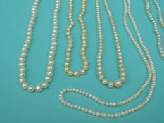 Seven pearl necklaces including a two strand pearl necklace with 9ct gold clasp,