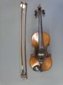 A late 19th / early 20thC violin with 36cm single piece back, two bows and fitted case.