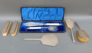 An Art Deco hallmarked silver engine turned dressing table set comprising hand mirror and four