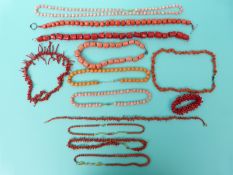 Three coral necklaces made up of barrel shaped beads, two pale coral beaded necklaces,