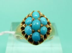 A Victorian yellow metal ring set with seven turquoise cabochons (Size N)