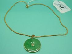 A 9ct gold pendant set with a bi-disc of jadeite with Chinese character to the centre,