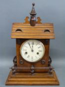 A German mantel/shelf clock in the form of a building with steps around the base,