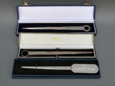 Two cased feature hallmarked silver letter openers formed as meat skewers together with a white