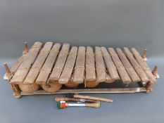 A tribal/African xylophone with attached gourds under the keys to enhance the sound