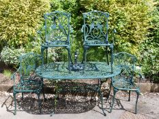 A painted cast metal garden table and four chairs,