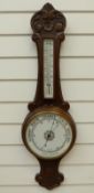 Aneroid banjo style barometer with bold lettering on white enamel dial,