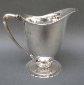 A George VI Charles Boyton Arts & Crafts hallmarked silver jug with hammered finish,