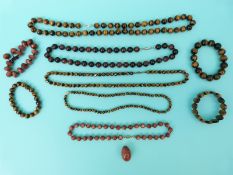 Three tigers eye beaded necklaces and three bracelets together with a sunstone beaded necklace and