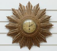 A c1950 sunburst wall clock with French movement,