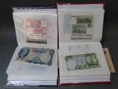 Two albums containing approximately 120 world bank notes, includes a UK L.K.