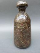A late 19th/20thC turned serpentine door stop of bottle form,