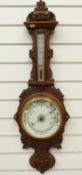 Aneroid wall barometer c1910 with carved oak surround, thermometer incorporated above,