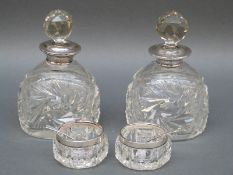 A pair of silver mounted cut glass scent bottles London 1927,