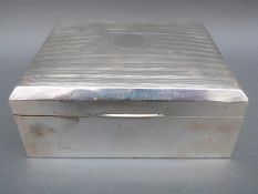 A large hallmarked silver cigarette or cigar box with engraved decoration to lid, Birmingham 1919,