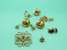 A collection of yellow metal and 9ct gold earrings and a 9ct gold brooch set with a sapphire, 9.5g.