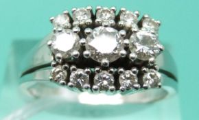 A 14ct white gold ring set with round brilliant cut diamonds in three rows,