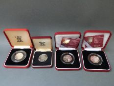 Four cased silver proof 50 pence coins, two with certificates,