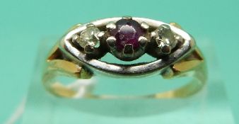 An 18ct gold ring set with a ruby and two diamonds in a platinum setting (Size P)