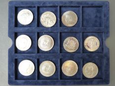 Eleven South African silver crown sized 50c coins