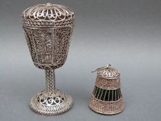 A possibly Russian white metal filigree pot pourri with scrolling decoration and silver marks to