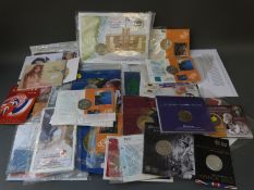 Over 40 commemorative coin packs, includes Millennium, Titanic etc.