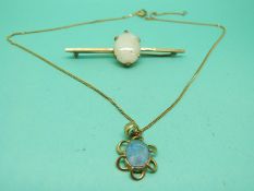 A 9ct gold brooch set with an oval opal cabochon and a 9ct gold pendant set with an opal doublet on