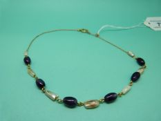 An 18ct gold necklace with alternating amethysts and pearls.