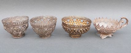 Three small white metal filigree bowls with all over pierced decoration and a white metal filigree