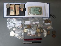 A small folder of wartime bank notes, PoW coins, two pens,