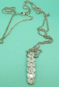 An 18ct white gold pendant set with 12 baguette cut diamonds in pairs with 19 marquise cut diamonds