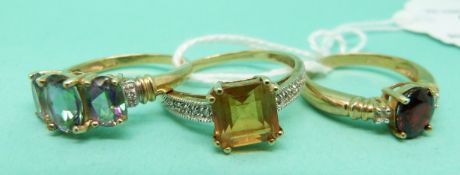 Three 9ct gold rings, one set with topaz,