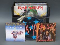 A case of LPs, 12 inch singles and picture discs including Iron Maiden, UFO, WASP and Bon Jovi,