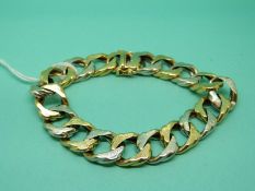 An 18ct gold bi-coloured bracelet made up of curb links, 70.3g.