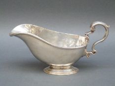 A George V hallmarked silver sauce boat, London 1914, maker's mark rubbed, weight 339g,