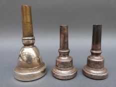 Three various wind instrument mouth pieces, including a tuba fhb 7B,