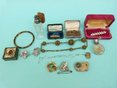 A cut glass scent bottle with hallmarked silver top, mourning brooch,