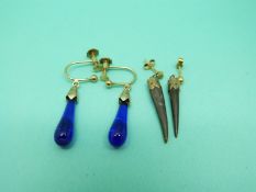 A pair of 9ct gold earrings set with blue glass and a pair of yellow metal earrings set with horn
