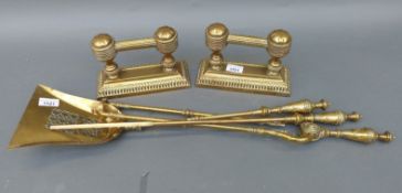 A set of 19thC neoclassical style brass fire irons and a pair of brass dogs