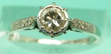 An 18ct white gold ring set with a round brilliant cut diamond measuring 0.