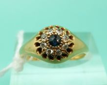 An 18ct gold ring set with a sapphire surrounded by diamonds,