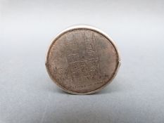 An Edward VII hallmarked silver tape measure with engraved Westminster Abbey to top,