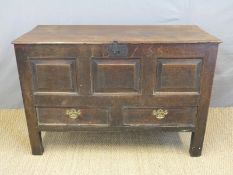 An 18th century oak mule chest with panelled front over two drawers, carved IB1735,