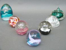 Seven glass paperweights including Caithness
