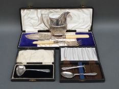 A cased hallmarked silver spoon and pusher christening set and a cased hallmarked silver pap spoon,